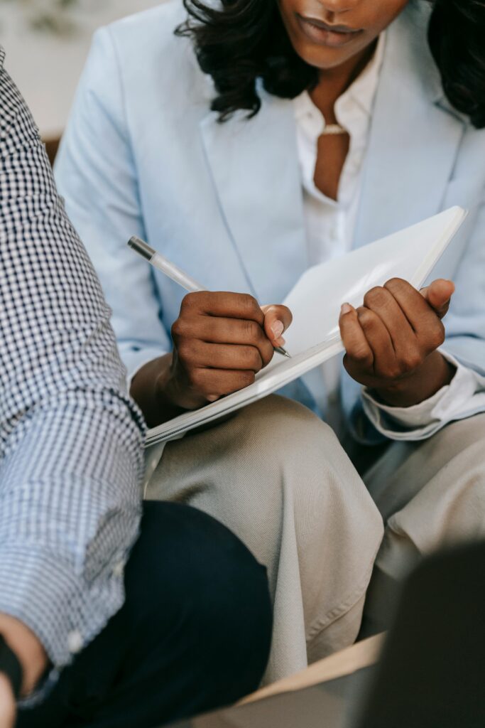 Close-up of a professional taking notes in a business meeting.